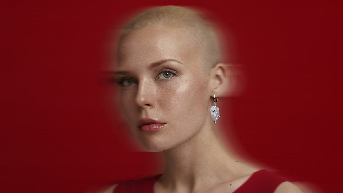 Helmia Orbita Hoop drop earrings baroque pearl and sterling silver on model.