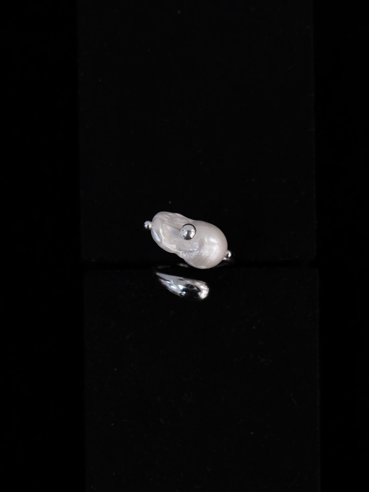Helmia Orbita Lumina Grande baroque pearl ring with silver band.